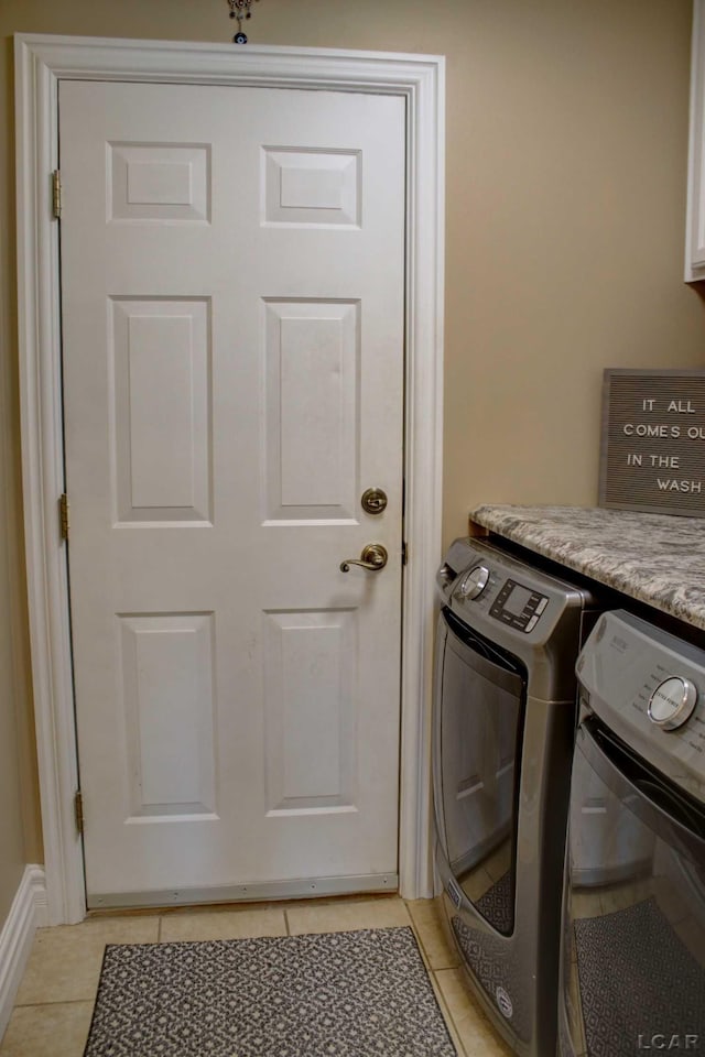 laundry room featuring light tile patterned floors and washing machine and dryer