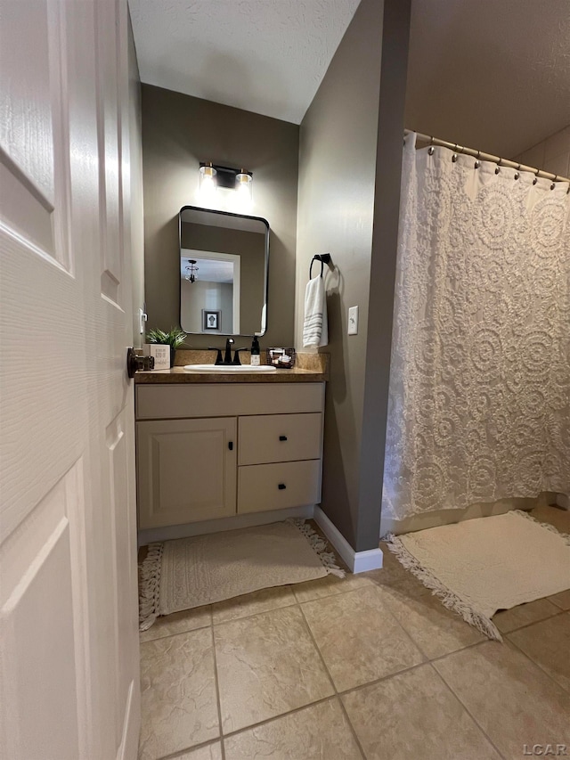 bathroom with vanity and a textured ceiling