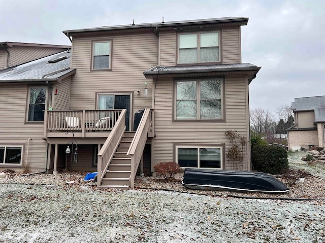 rear view of property featuring a deck