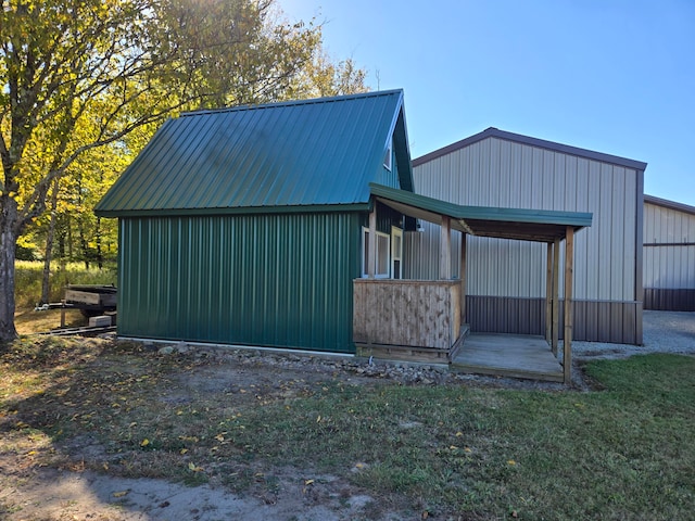 view of side of home with an outdoor structure and a lawn