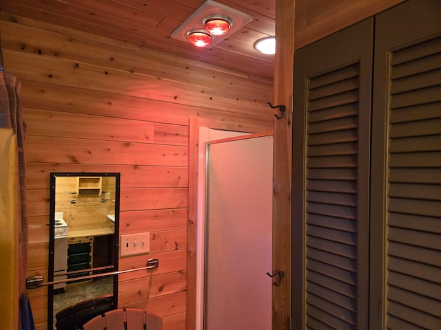 bathroom featuring wooden walls and wooden ceiling