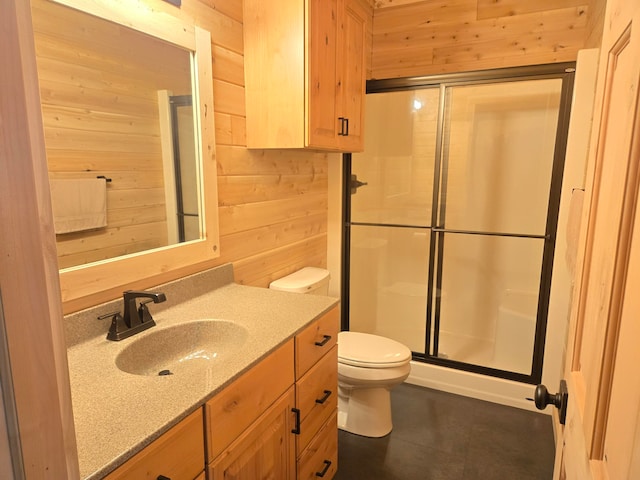 bathroom with vanity, toilet, an enclosed shower, and wood walls