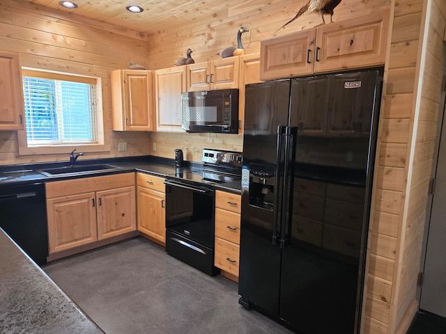 kitchen featuring backsplash, black appliances, sink, wooden walls, and light brown cabinetry