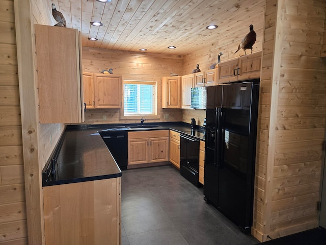 kitchen with decorative backsplash, wooden walls, sink, black appliances, and light brown cabinets