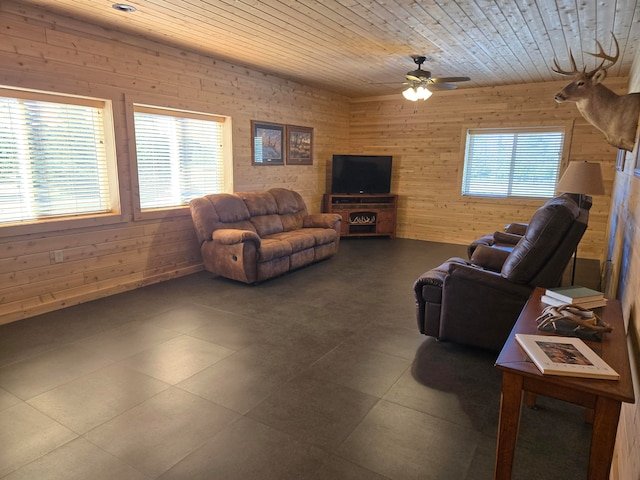 living room featuring wooden walls, ceiling fan, and wood ceiling