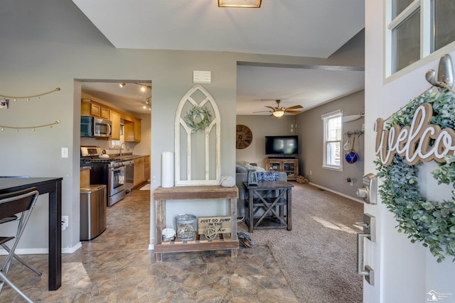 living room with carpet flooring, ceiling fan, and sink