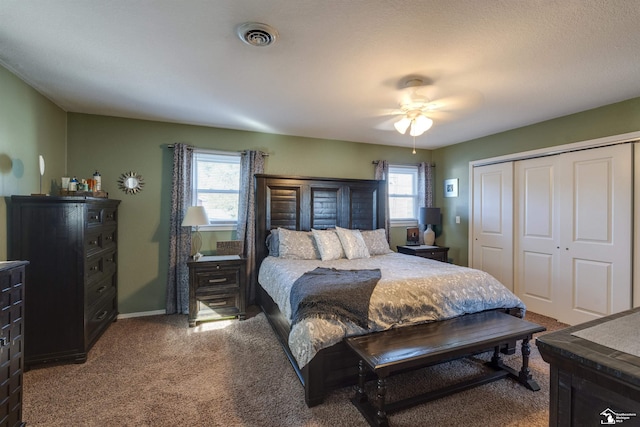 carpeted bedroom featuring a closet and ceiling fan