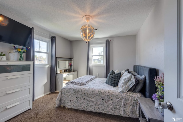 carpeted bedroom with a textured ceiling