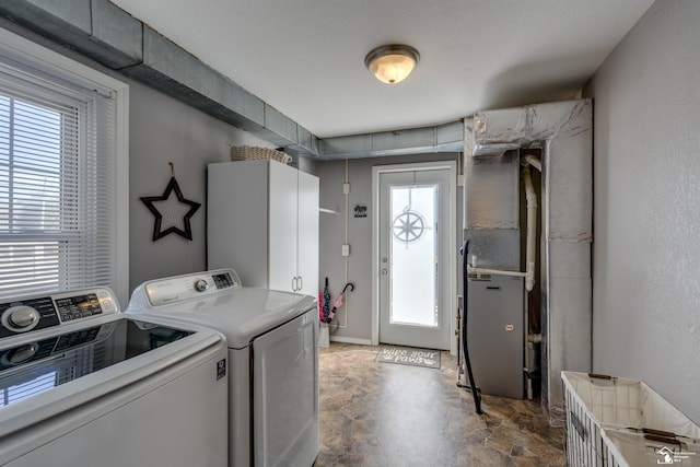 laundry room featuring stone finish flooring, separate washer and dryer, and laundry area