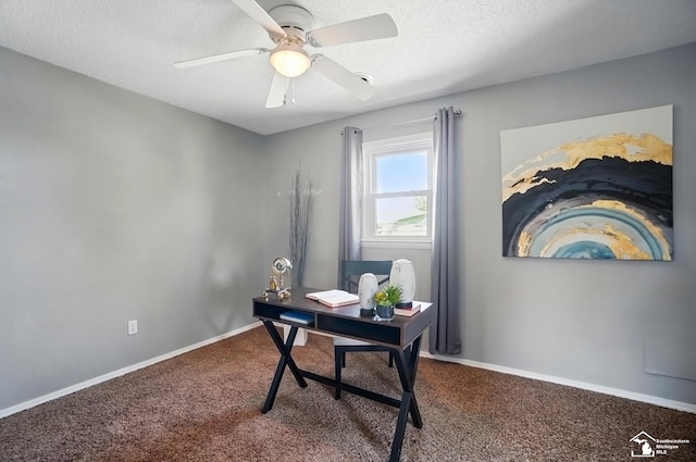 office area with carpet, ceiling fan, baseboards, and a textured ceiling