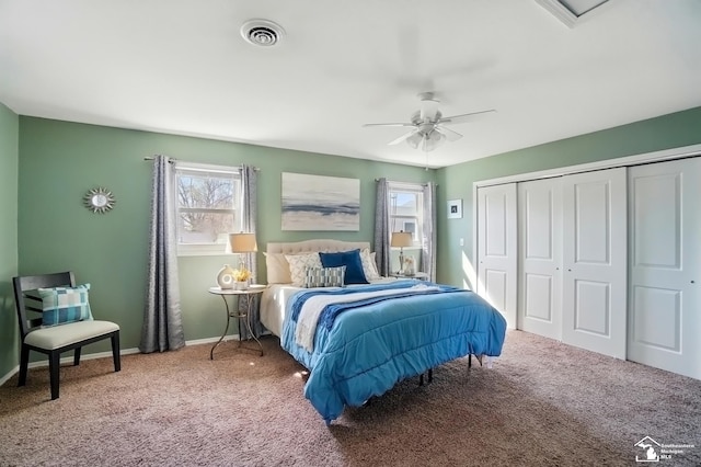carpeted bedroom with visible vents, a ceiling fan, baseboards, and a closet