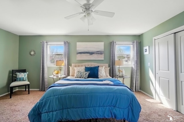 carpeted bedroom featuring baseboards, ceiling fan, multiple windows, and a closet
