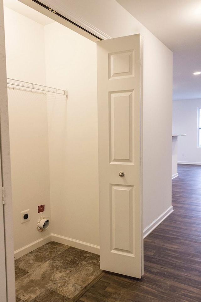 washroom with electric dryer hookup and dark wood-type flooring