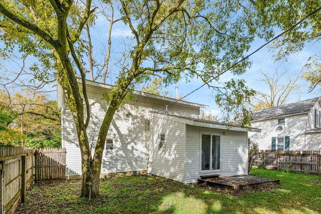 rear view of property featuring a yard