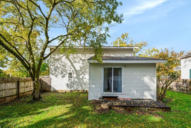 back of property featuring a lawn