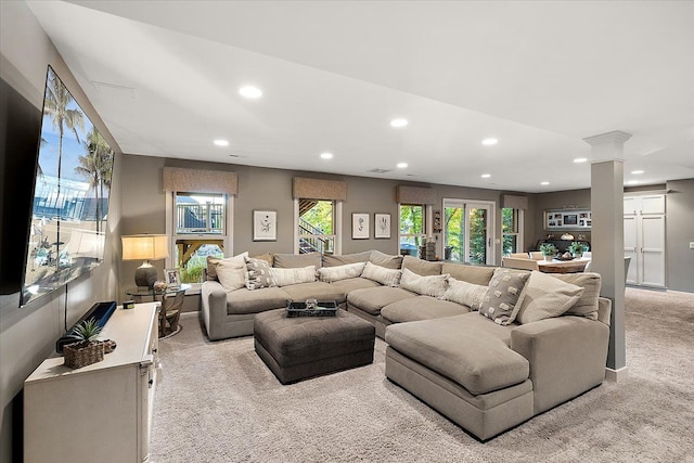 living room featuring carpet flooring, recessed lighting, and ornate columns