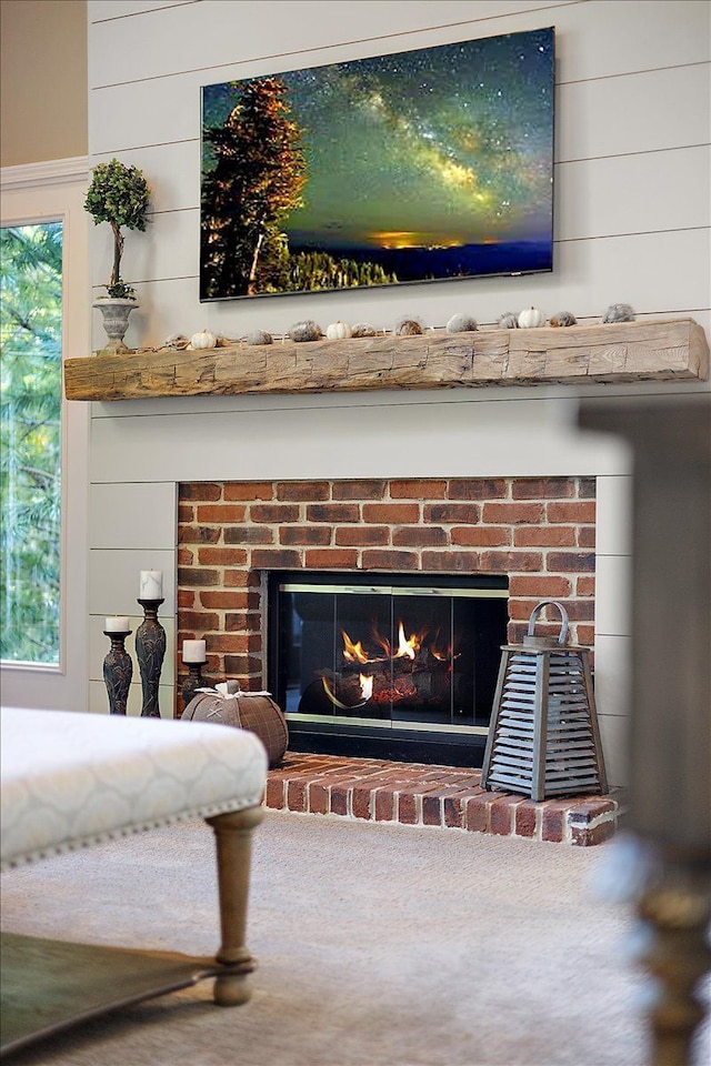 details featuring wooden walls and a brick fireplace