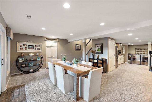 dining area with a fireplace, stairway, recessed lighting, and visible vents