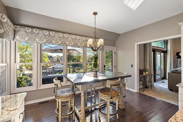 dining space with a healthy amount of sunlight, dark hardwood / wood-style flooring, and lofted ceiling