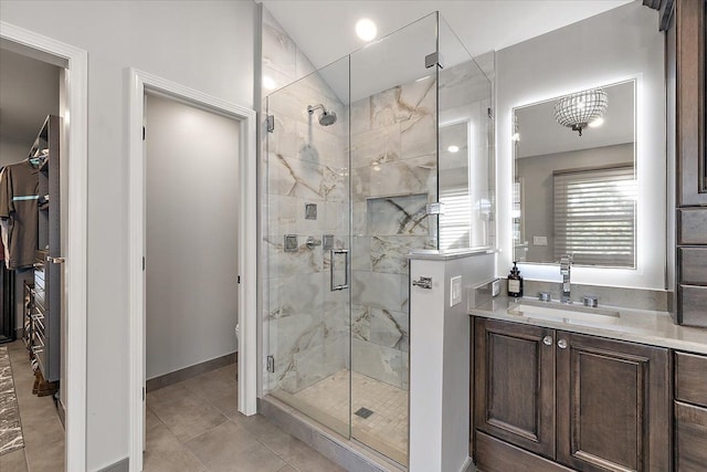 full bathroom with tile patterned floors, toilet, a shower stall, baseboards, and vanity