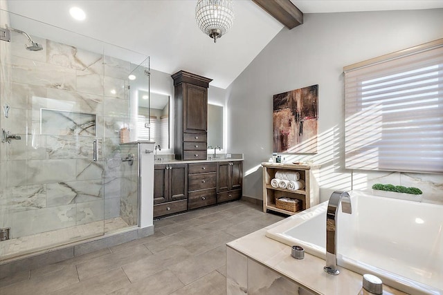 bathroom with vanity, a shower stall, vaulted ceiling with beams, and a healthy amount of sunlight