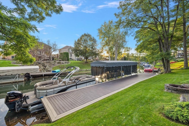 dock area featuring a yard, a water view, and an outdoor fire pit