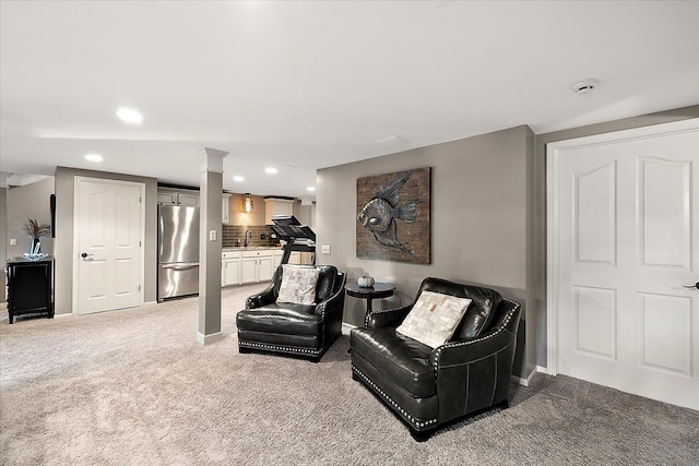 living area featuring light colored carpet and sink