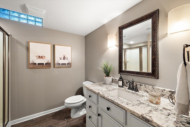 bathroom with hardwood / wood-style floors, vanity, and toilet