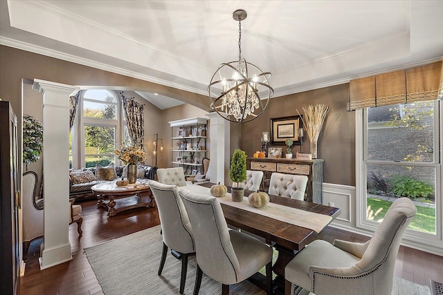 dining room featuring a tray ceiling, arched walkways, dark wood-type flooring, and a healthy amount of sunlight