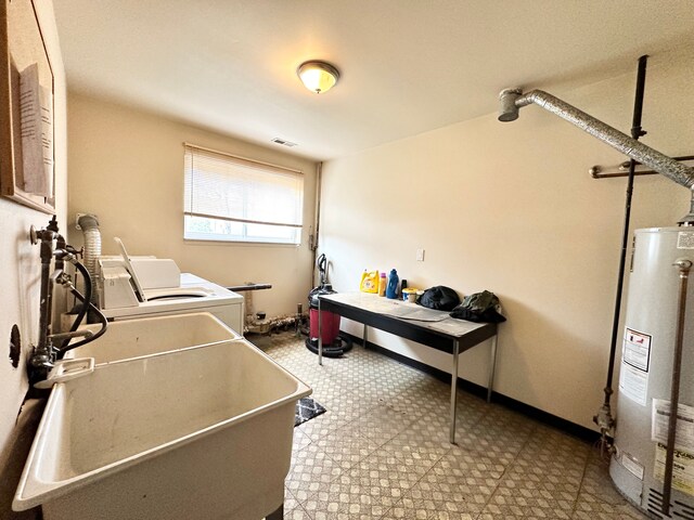 51316 Johns Dr Unit 14, Chesterfield, MI 48047 - laundry room featuring gas water heater, washer and clothes dryer, and tile patterned floors