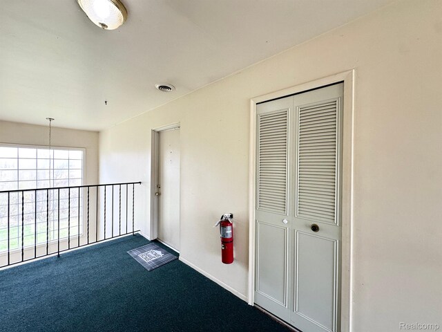 51316 Johns Dr Unit 14, Chesterfield, MI 48047 - corridor with dark carpet and baseboards