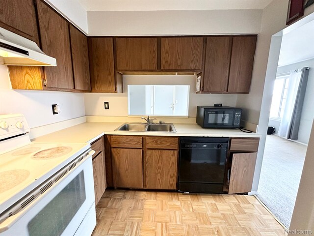 51316 Johns Dr Unit 14, Chesterfield, MI 48047 - kitchen with black appliances, ventilation hood, a sink, and light countertops