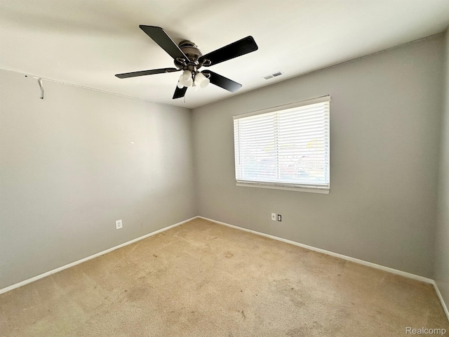 51316 Johns Dr Unit 14, Chesterfield, MI 48047 - spare room featuring light colored carpet, baseboards, and ceiling fan