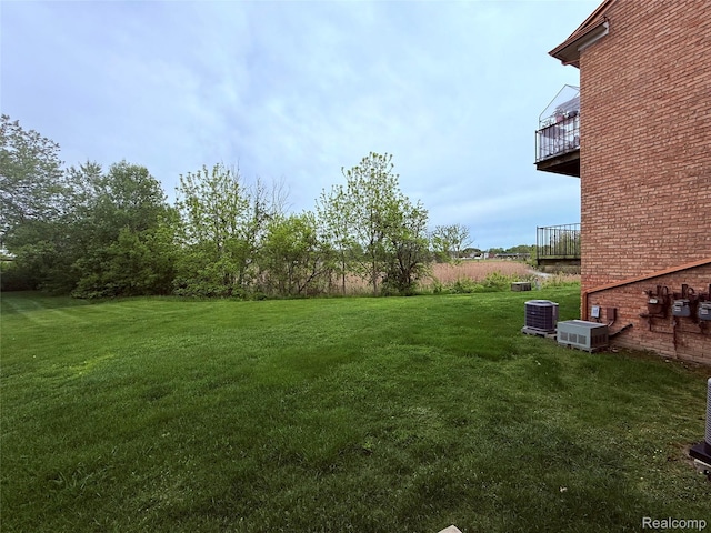 51316 Johns Dr Unit 14, Chesterfield, MI 48047 - view of grassy yard with central AC and a balcony