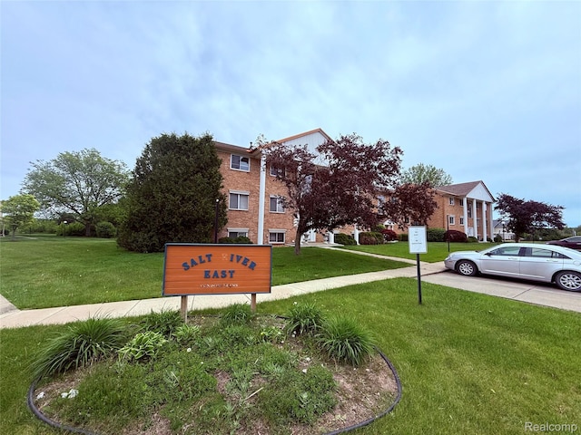51316 Johns Dr Unit 14, Chesterfield, MI 48047 - community / neighborhood sign featuring a lawn