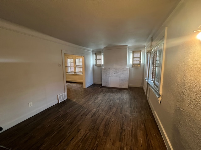 unfurnished room with dark hardwood / wood-style flooring and a wealth of natural light