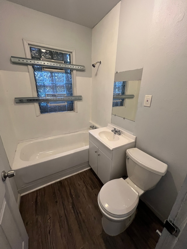 full bathroom featuring hardwood / wood-style flooring, vanity, toilet, and tub / shower combination