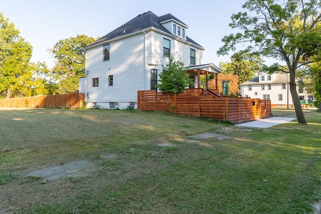 view of side of property with a lawn