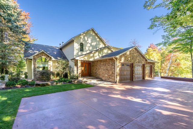 view of property featuring a garage and a front yard