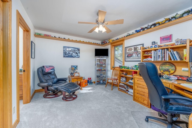 carpeted office featuring ceiling fan