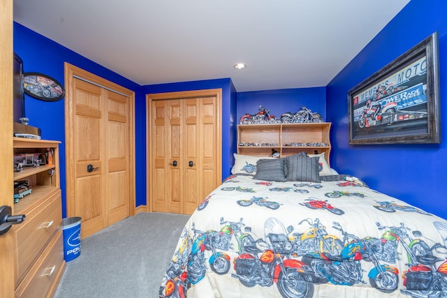 bedroom with carpet flooring and multiple closets