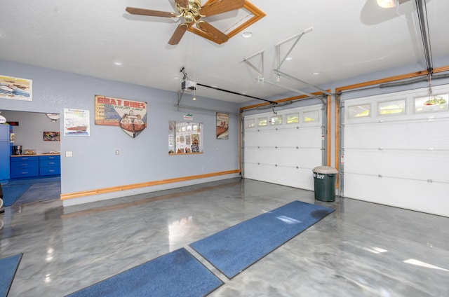 garage featuring ceiling fan and a garage door opener