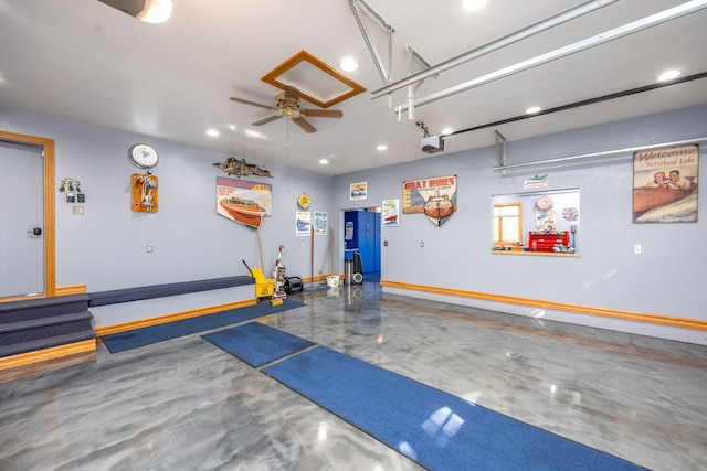 garage with a garage door opener and ceiling fan