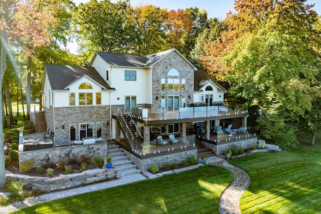 rear view of house with a patio area, a yard, and a wooden deck