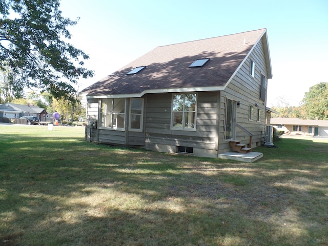 back of property with a lawn