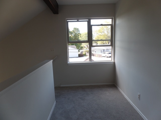 additional living space with carpet flooring and vaulted ceiling with beams