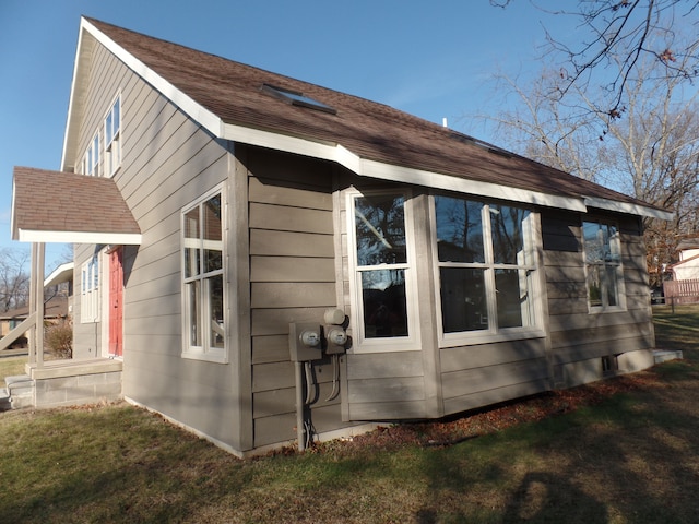 view of home's exterior with a lawn