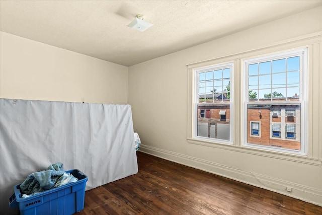 interior space with hardwood / wood-style floors and a textured ceiling