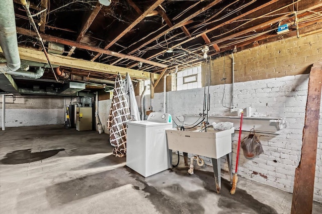 basement with washer / dryer, water heater, and sink