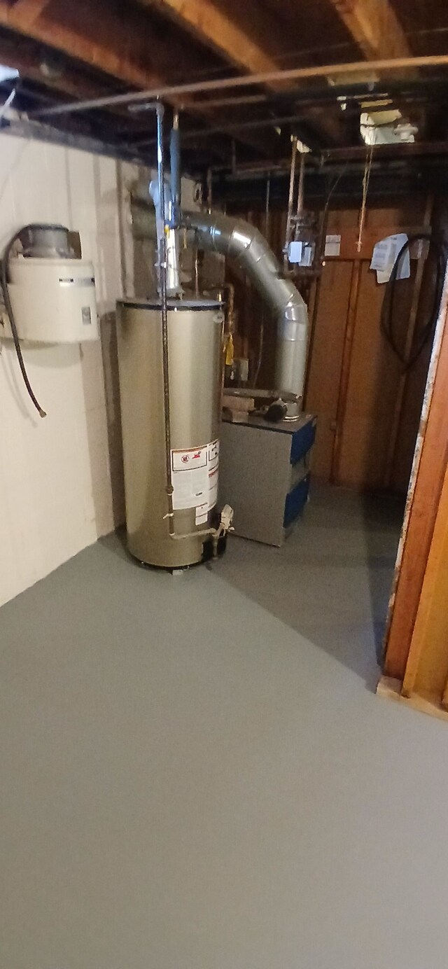 utility room featuring water heater